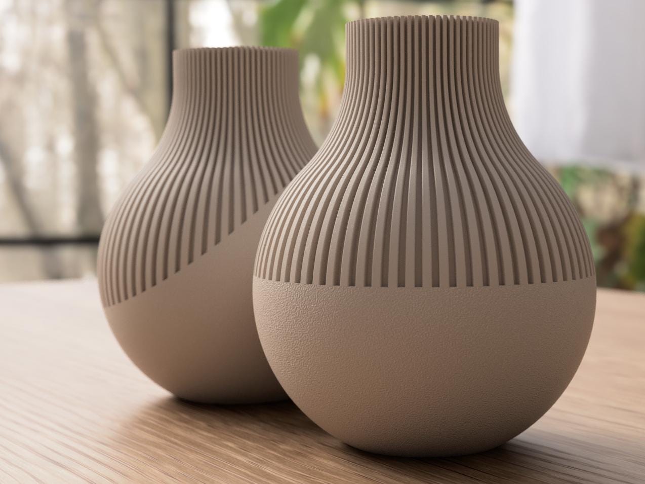 Two beige textured vases on a wooden surface with a blurred background