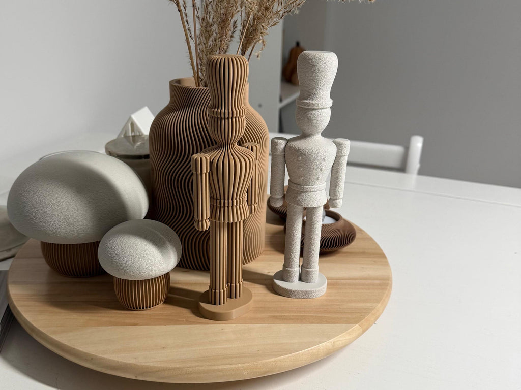 Decorative items including vases and a wooden figurine on a round wooden table.