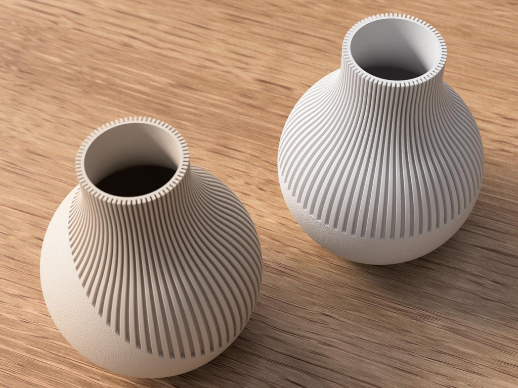 Two white textured vases on a wooden surface