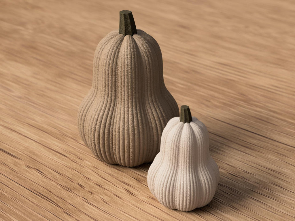 Two decorative gourds on a wooden surface