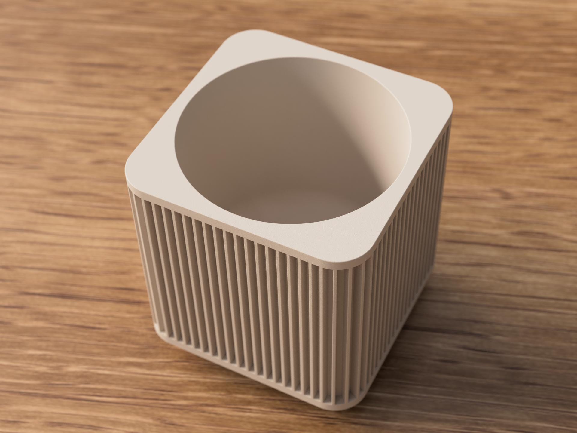 Beige ceramic planter with textured surface on a wooden table