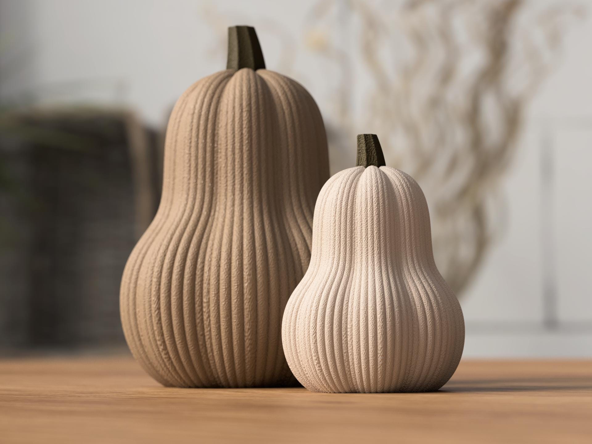 Two decorative gourds on a wooden surface with a blurred background