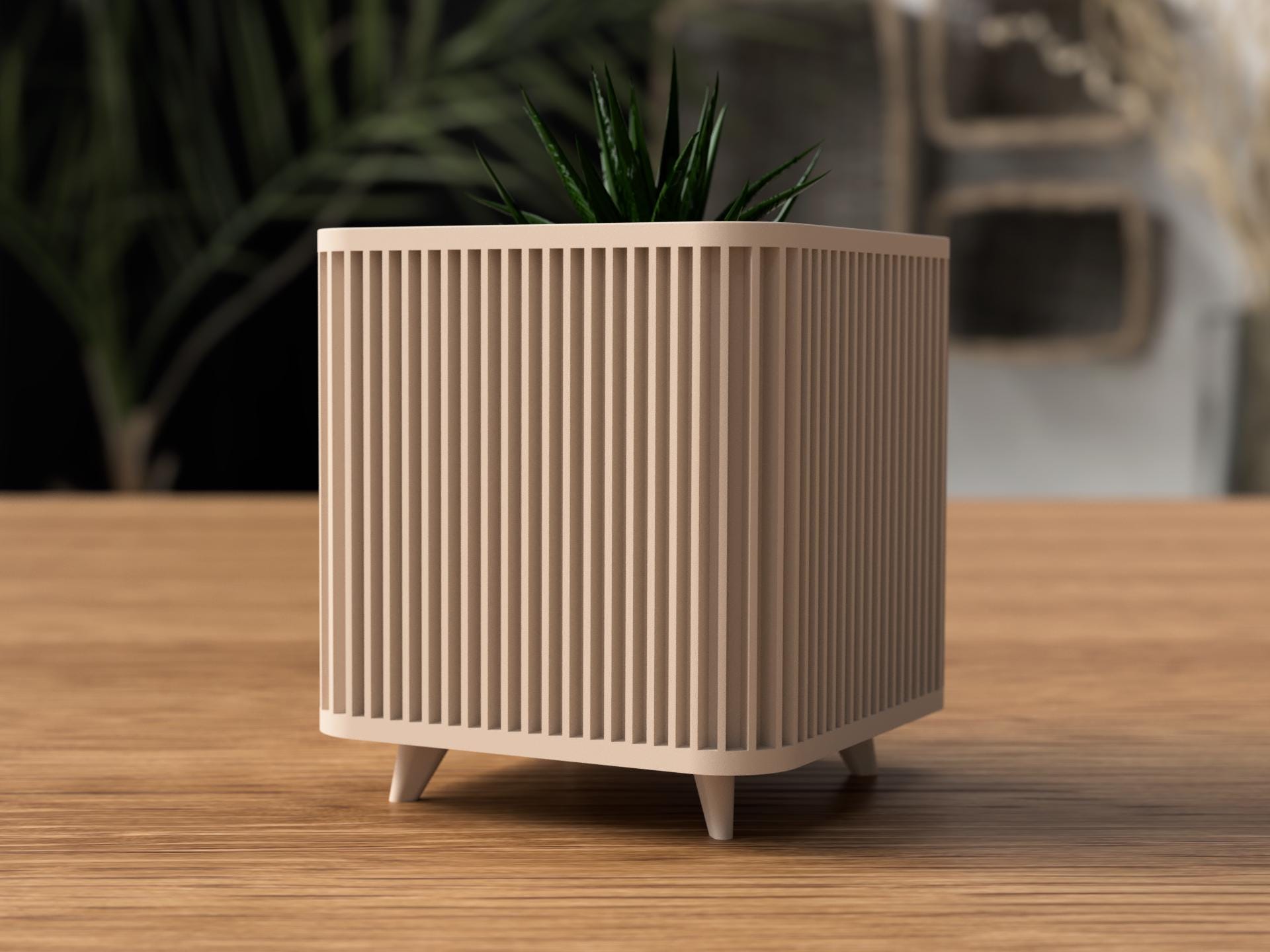 Beige textured planter with a plant on a wooden surface