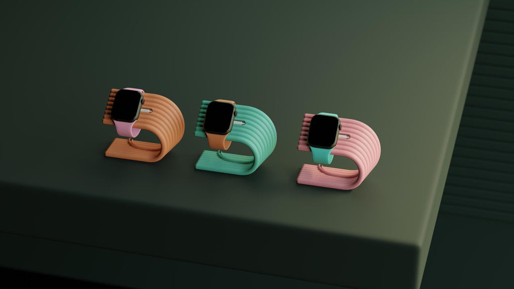 Three colorful watch stands on a dark surface