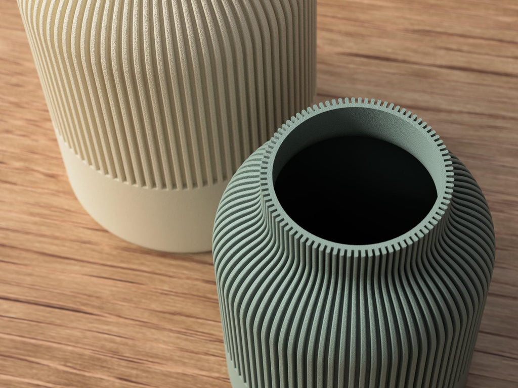 Two textured vases on a wooden surface