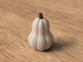 White decorative pumpkin on a wooden surface