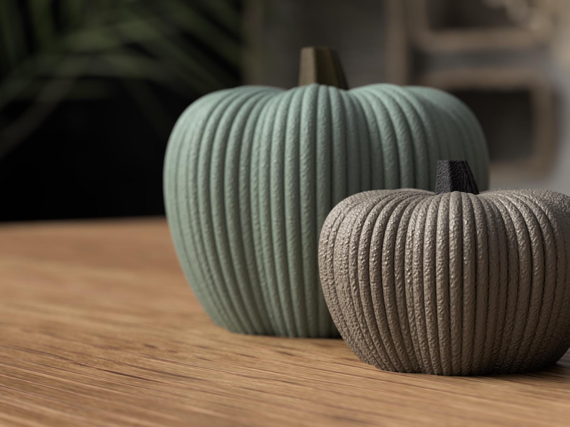 Two ribbed pumpkins, one green and one brown, on a wooden surface with a blurred background.