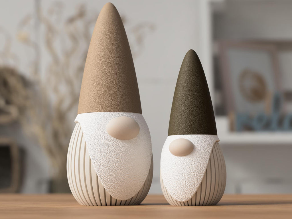 Two decorative gnomes with brown and black hats on a wooden surface.