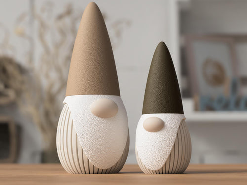 Two decorative gnomes with brown and black hats on a wooden surface.