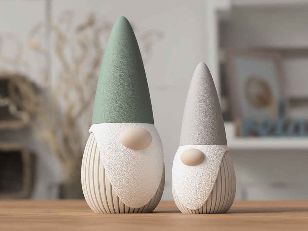 Two ceramic gnomes on a wooden surface with a blurred indoor background