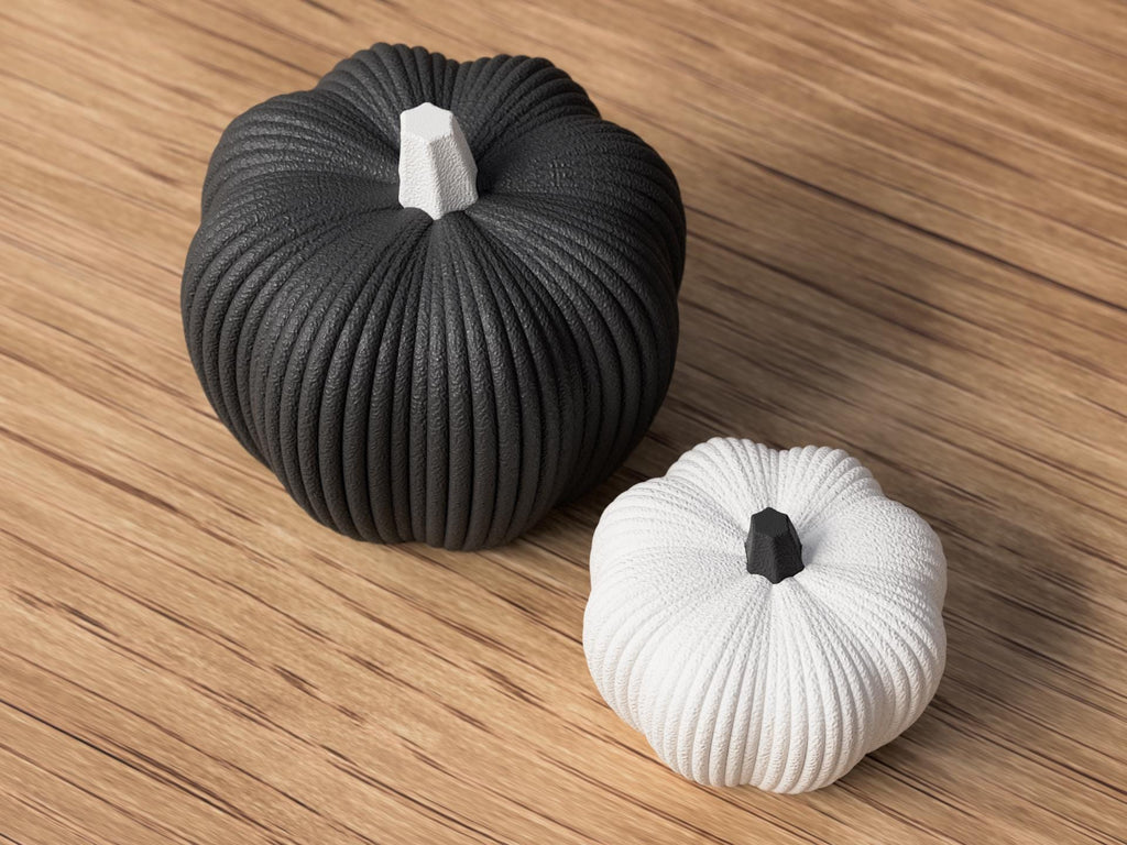 Black and white textured pumpkins on a wooden surface