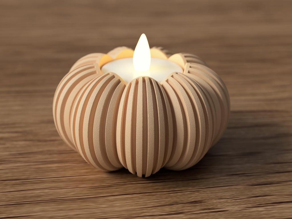 Wooden pumpkin-shaped candle holder with a lit candle on a wooden surface