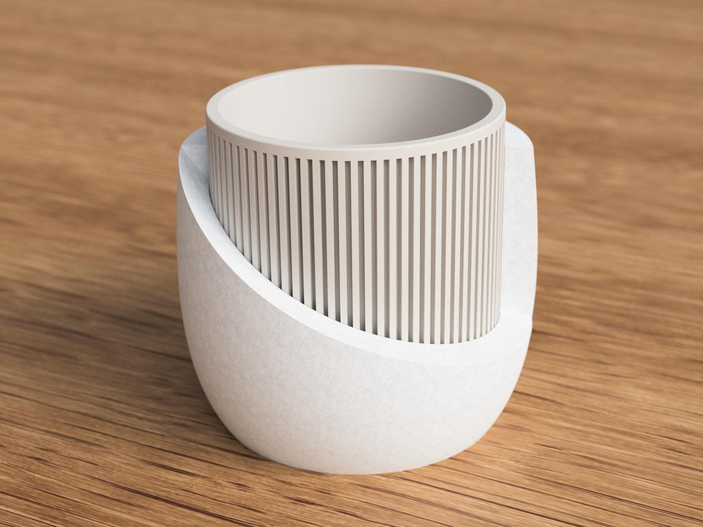 White ceramic planter with textured design on a wooden surface
