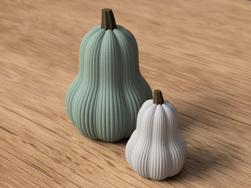 Two ribbed gourds, one green and one white, on a wooden surface.